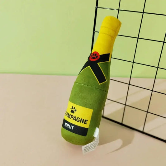 Plush dog toy shaped like a green champagne bottle with a yellow top.