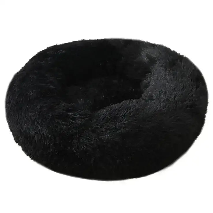 Circular black fluffy pet bed or cushion.