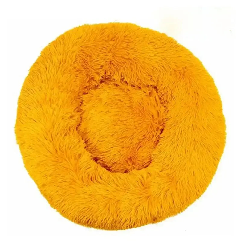 Circular, fluffy yellow pet bed with a raised rim and sunken center.