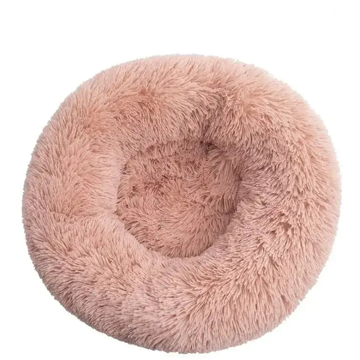 Fluffy, round, pink pet bed with a circular depression in the center.