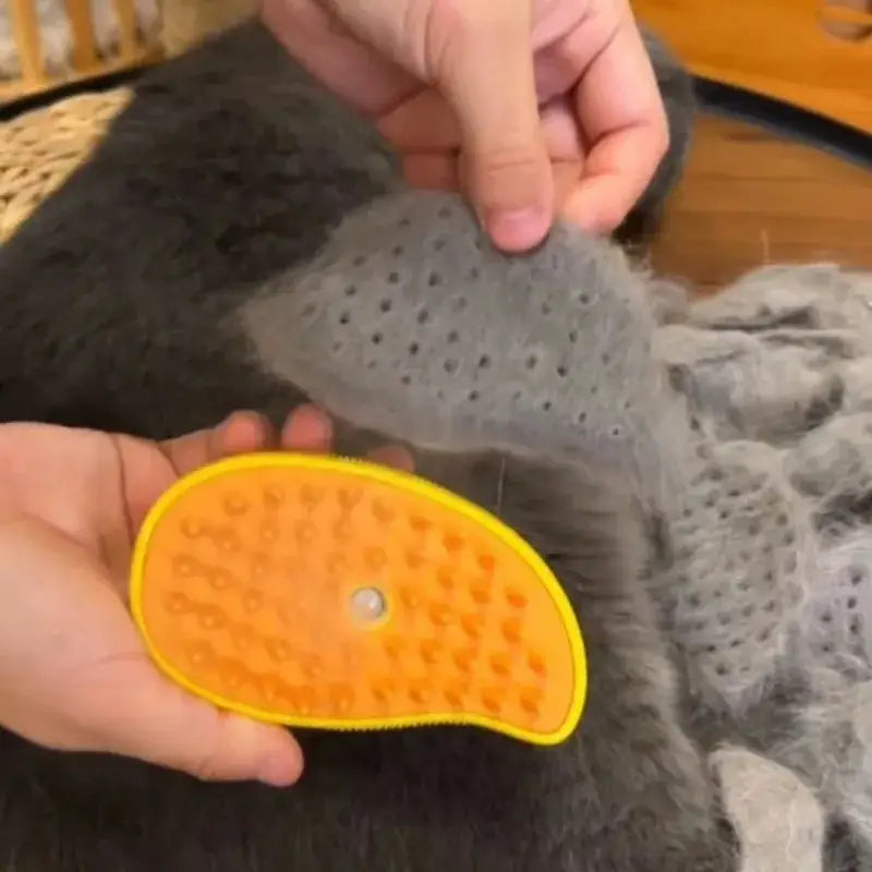 Yellow, crescent-shaped pet grooming tool with small bristles or nubs on its surface.