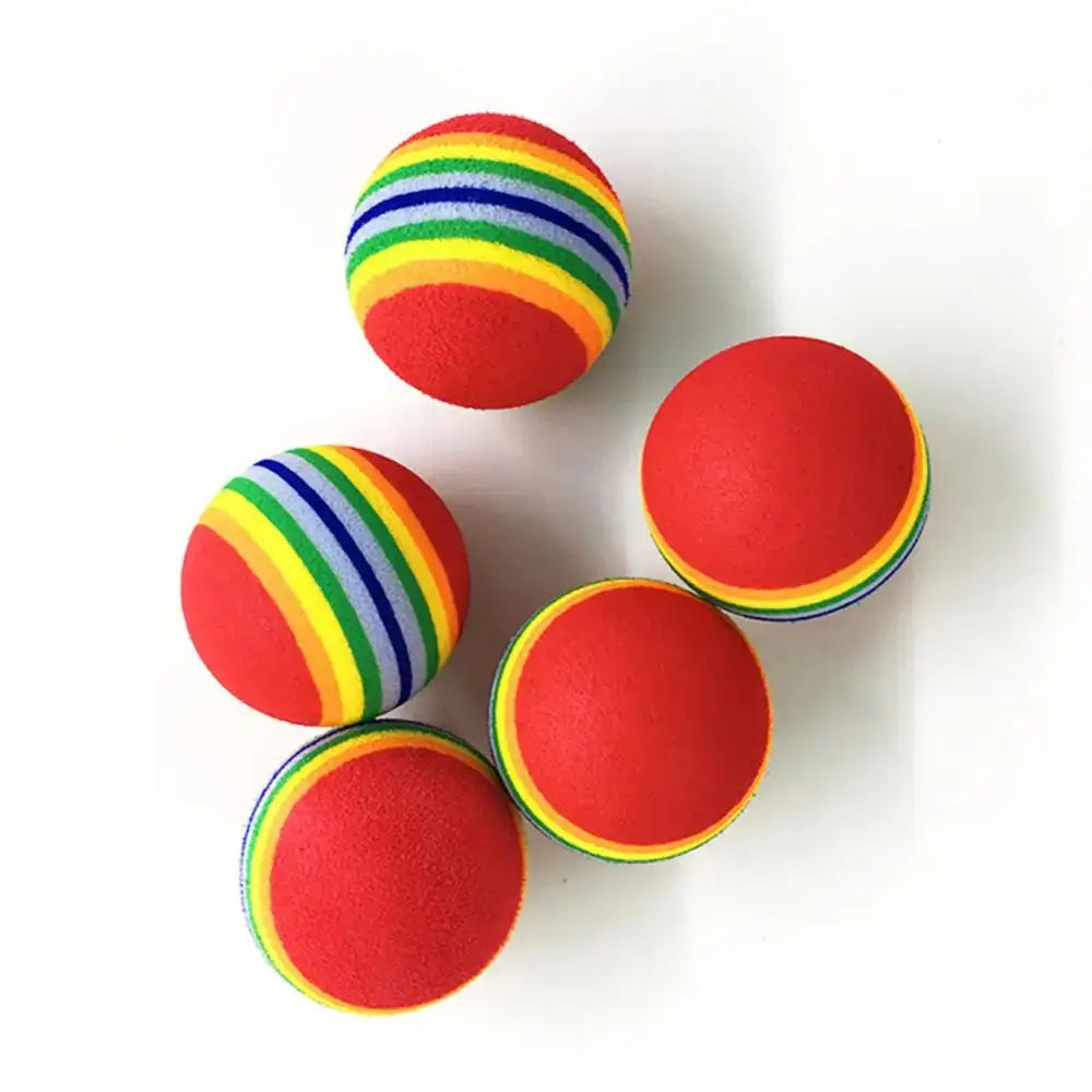 Colorful foam balls with rainbow stripes and red surfaces.