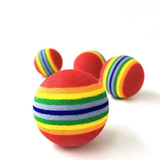 Rainbow-striped foam ball with a predominantly red surface.