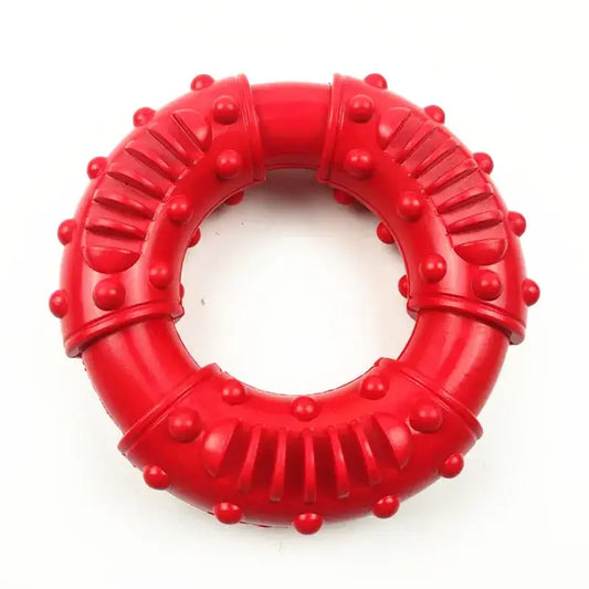 Red circular dog chew toy with textured ridges and bumps.