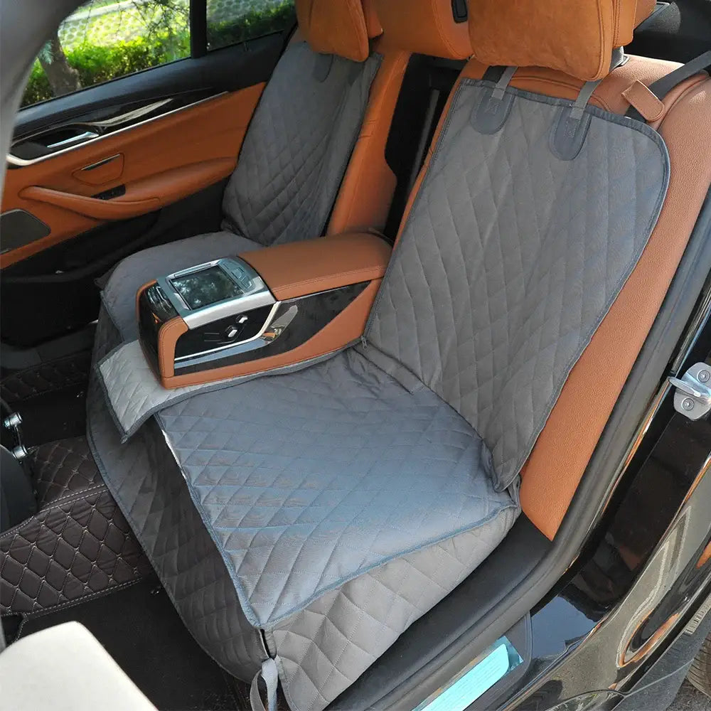 Car seat cover protecting leather upholstery in a luxury vehicle’s rear seat.