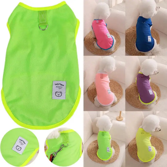 Bright neon green dog vest or shirt with a metal ring attachment and small logo patch.