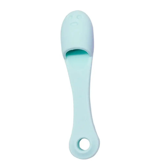 Mint green plastic foot scrubber with a long handle and curved scrubbing surface.