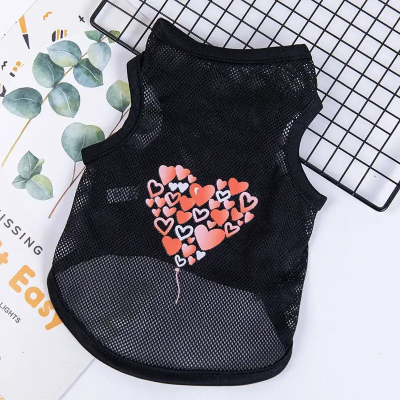 Black mesh pet vest with a heart design made of smaller colorful hearts.