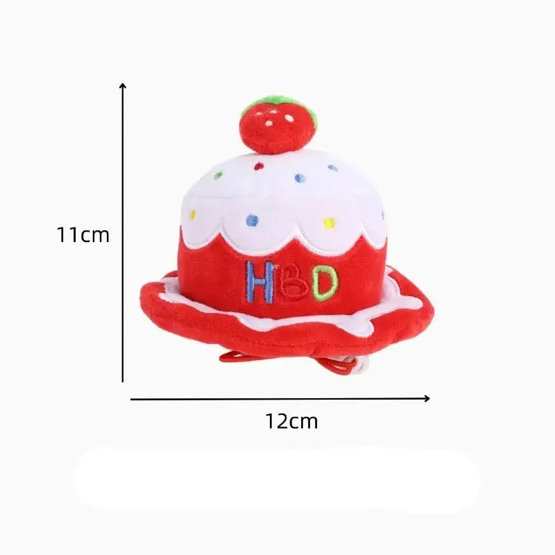 Decorative birthday cake-shaped hat with ’HBD’ text and a cherry on top.