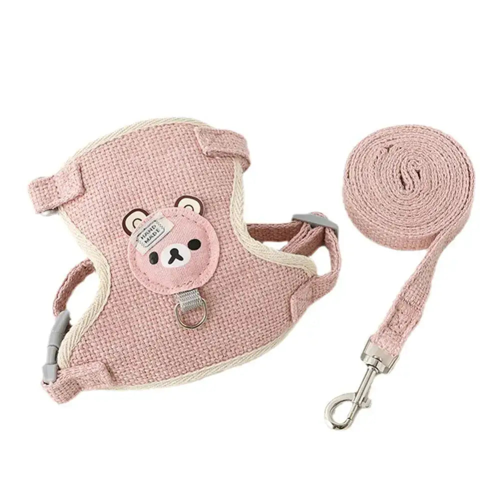 Pink pet harness with a bear face design and matching leash.