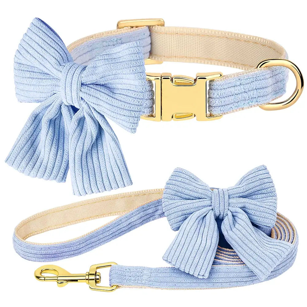 Dog collar and leash set with light blue corduroy bows and gold-tone hardware.