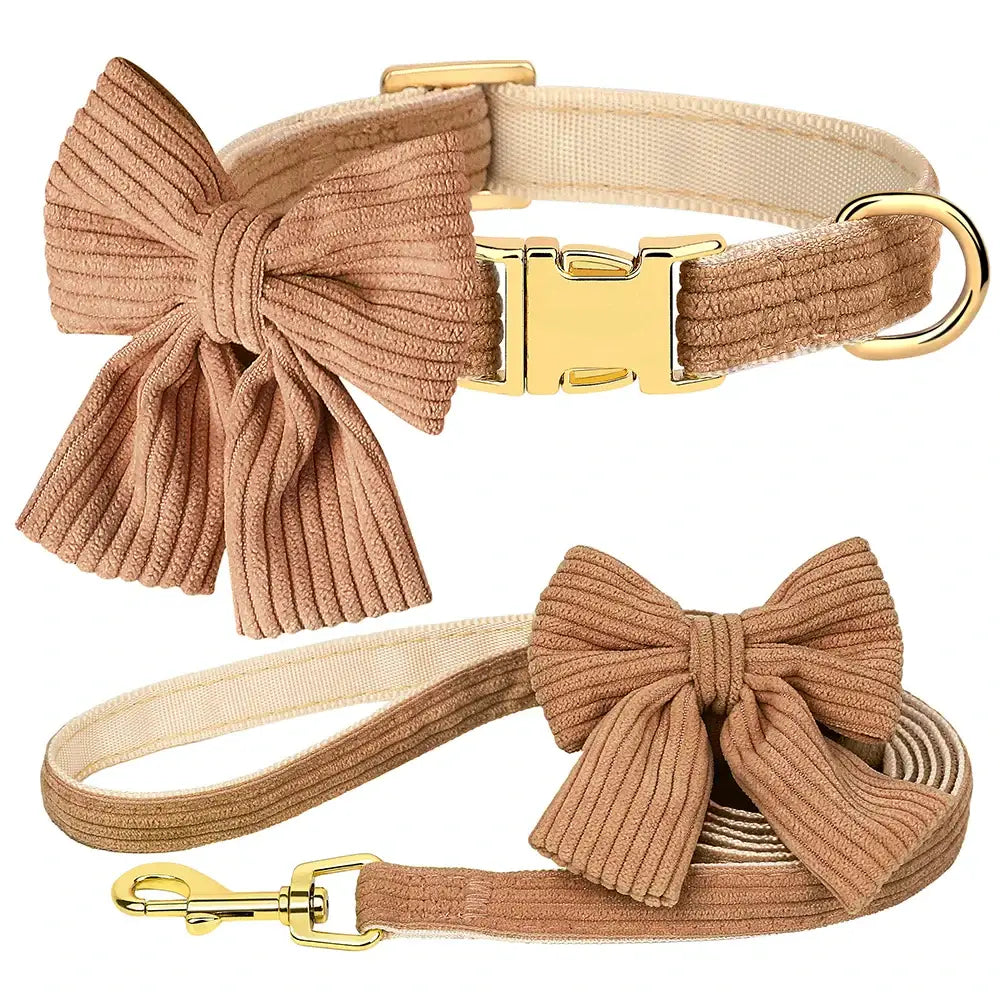 Dog collar and leash set with decorative beige corduroy bows and gold-toned hardware.