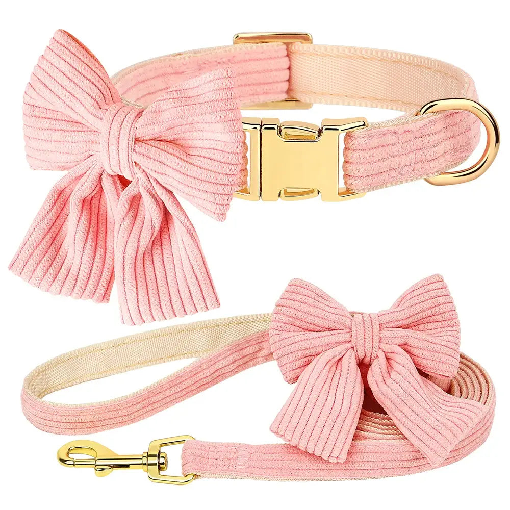 Pink corduroy dog collar and matching leash set with decorative bows.