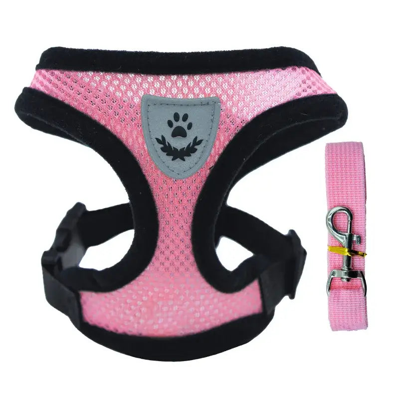 Pink mesh dog harness with black trim and a paw print emblem, accompanied by a matching leash.