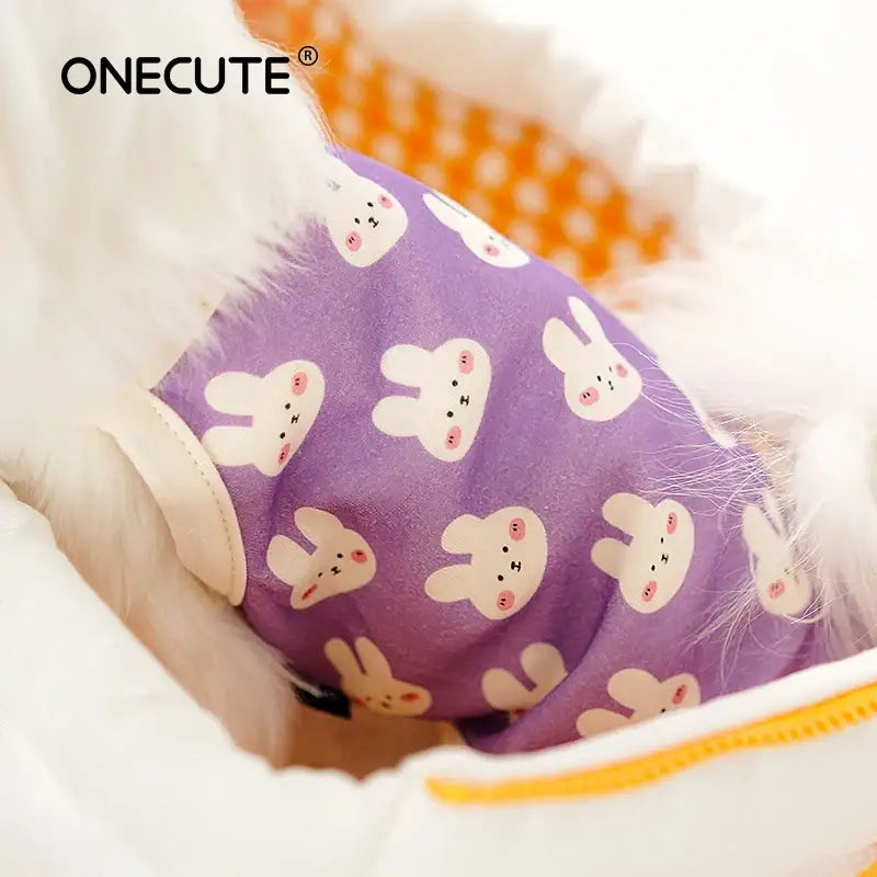 Purple baby bib with white bunny rabbit pattern.