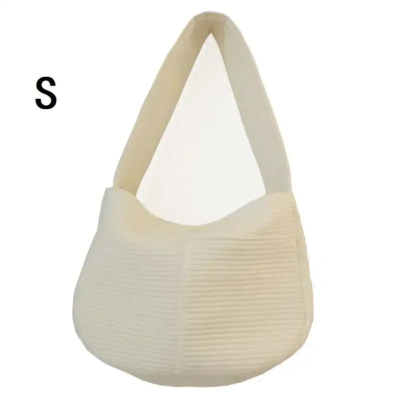 Cream-colored hobo-style handbag with a textured bottom half and smooth top half.