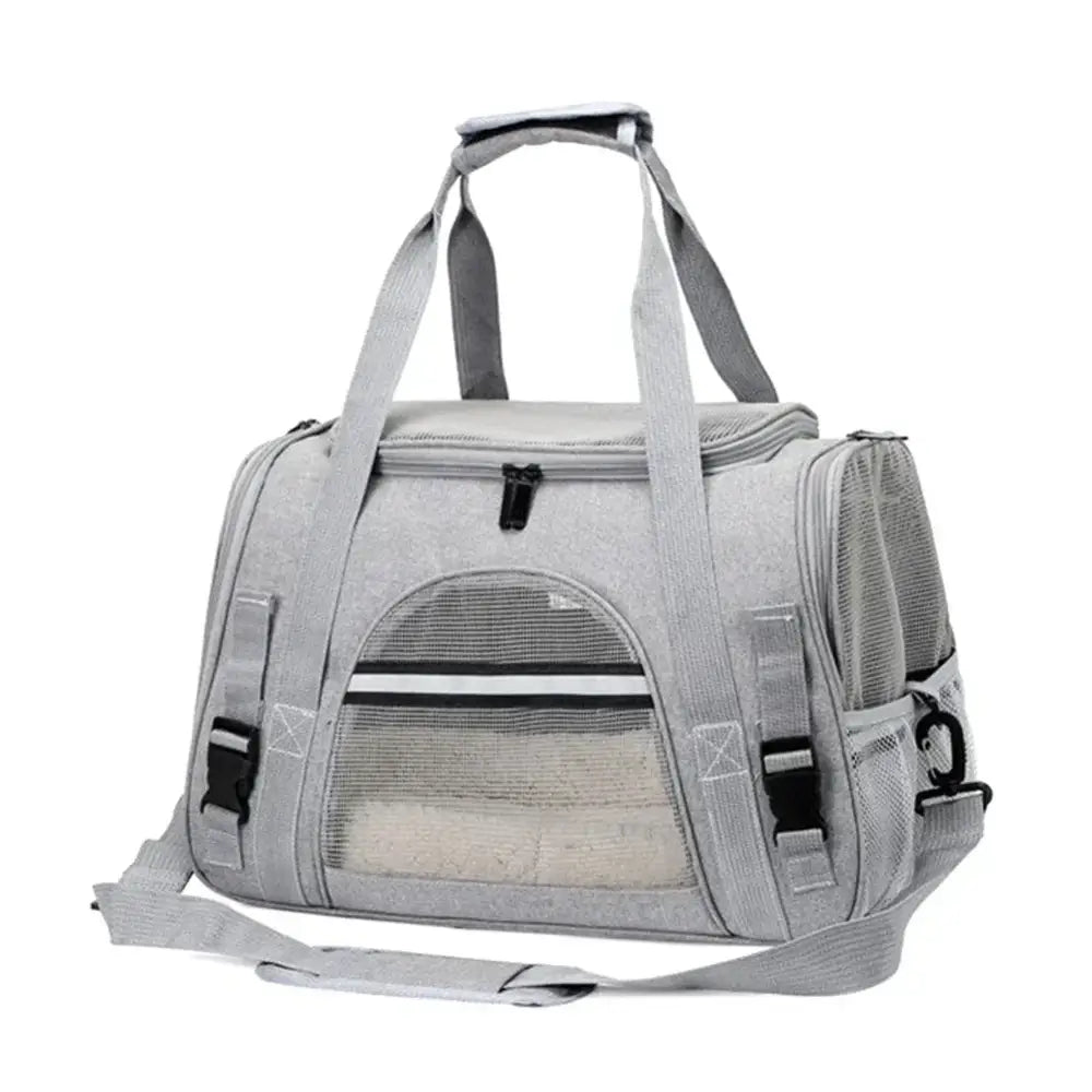 Pet carrier bag with mesh panels and multiple straps.