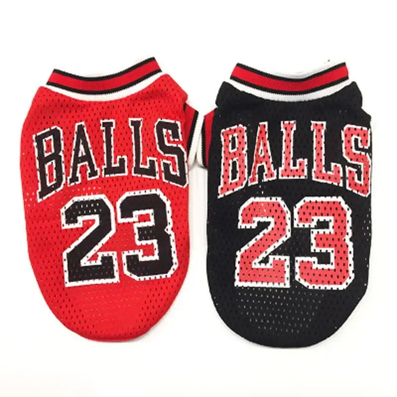 Two basketball-style jerseys for dogs with ’BALLS 23’’ printed on them, one red and one black.