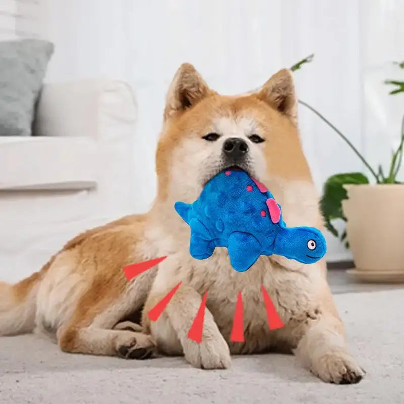 Akita dog holding a blue plush fish toy in its mouth.