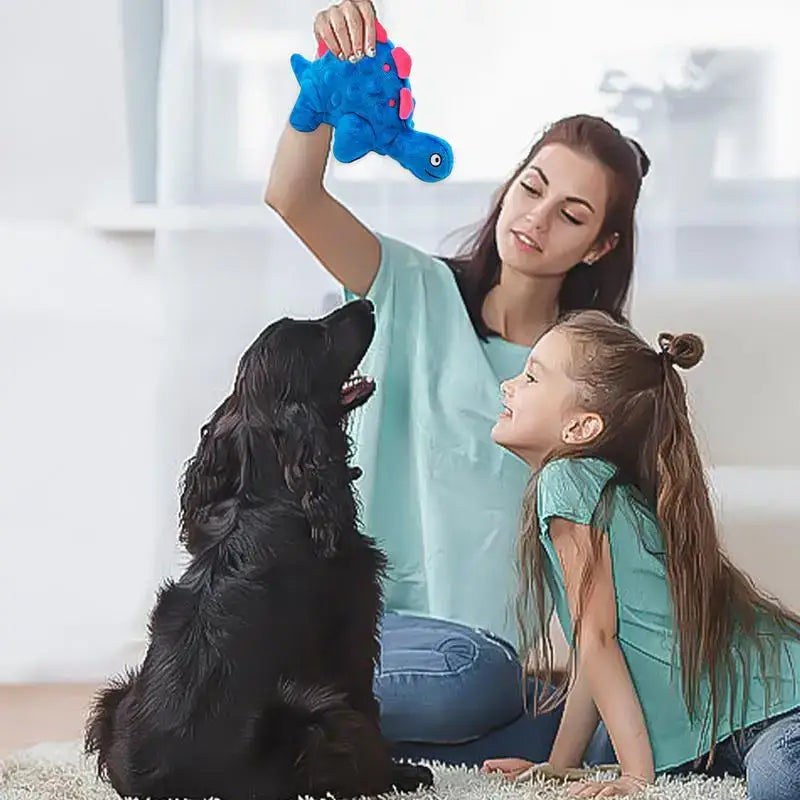 Blue plush toy elephant being held up.