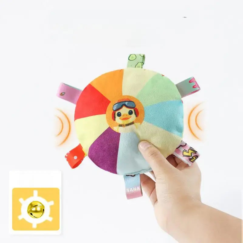 Colorful circular toy with cartoon animal faces on each segment, held by a hand.