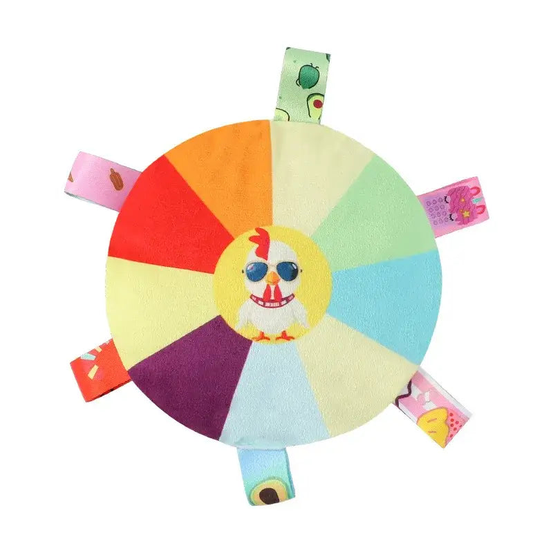 Colorful circular toy or mat with a smiling cartoon face in the center and fabric tags around the edges.