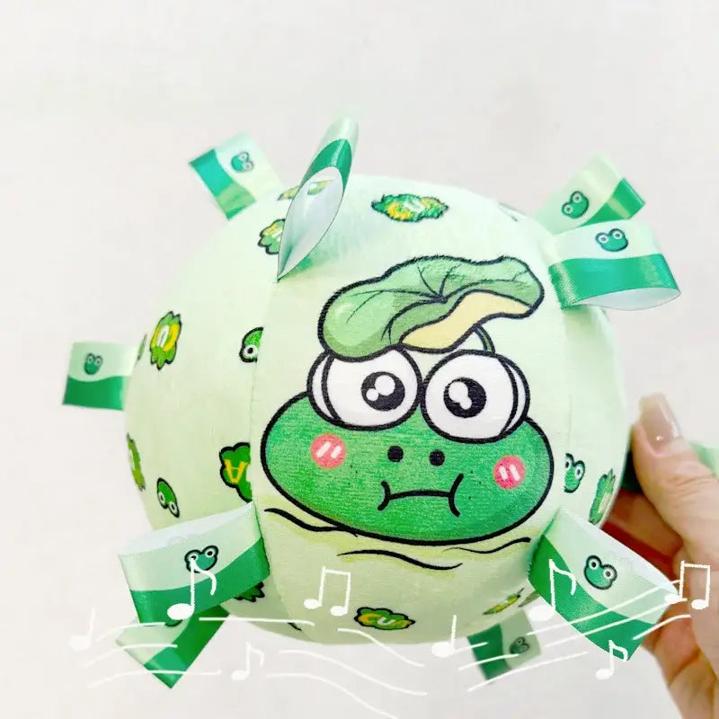 Cartoon-style green frog face on a round, light green object with decorative elements.