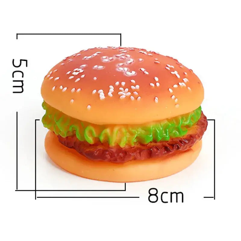 Plastic toy hamburger with sesame seed bun, lettuce, and patty.