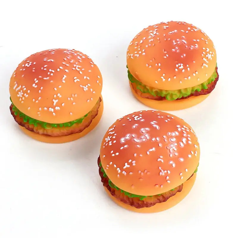 Three toy hamburgers with sesame seed buns and visible lettuce.