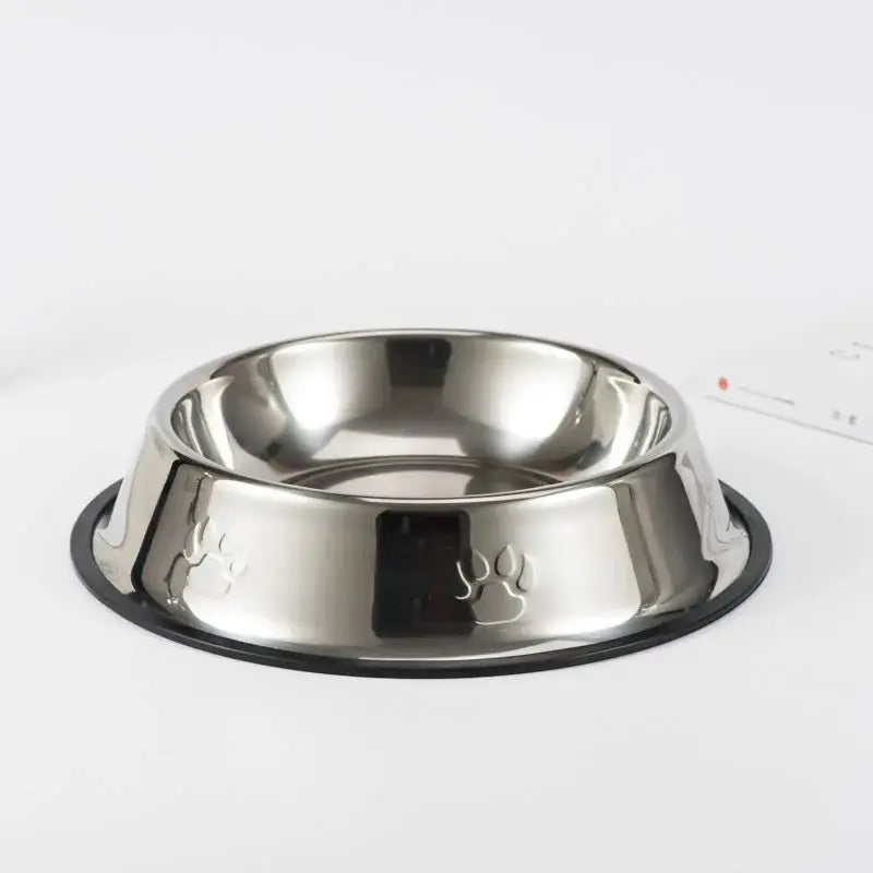 Stainless steel pet food bowl with a paw print design and non-slip base.