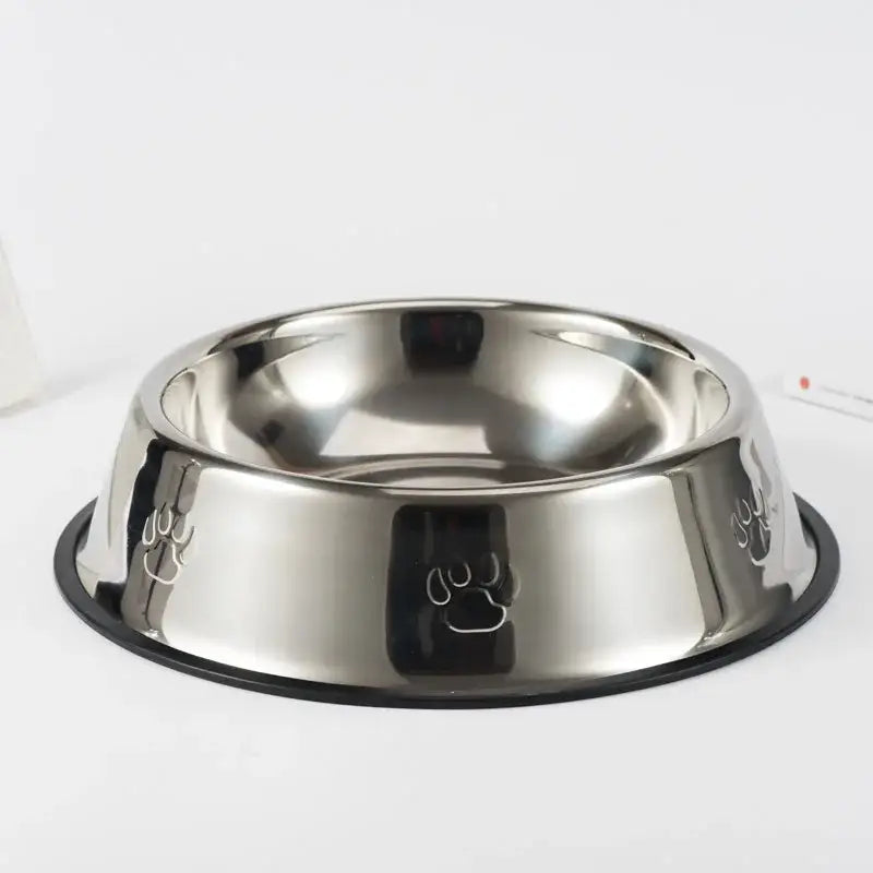 Stainless steel pet food bowl with paw print designs on the exterior.