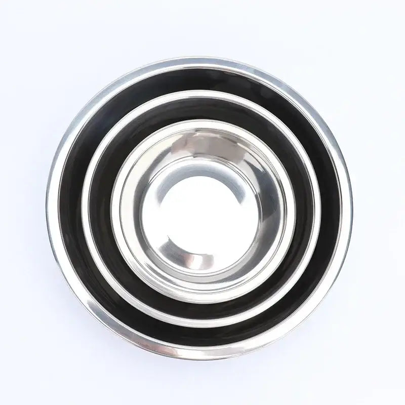 Set of nested stainless steel mixing bowls with black exterior bands.