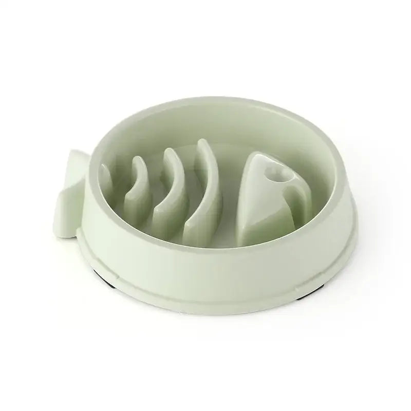 Pale green pet food bowl with raised interior ridges to slow eating.