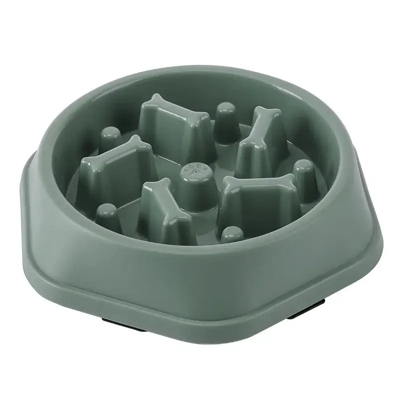 Sage green plastic pet food bowl with raised obstacles inside to slow eating.