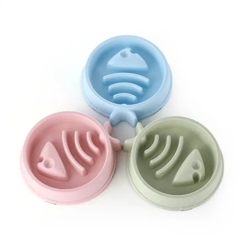 Three pastel-colored circular soap dishes with fish bone designs.