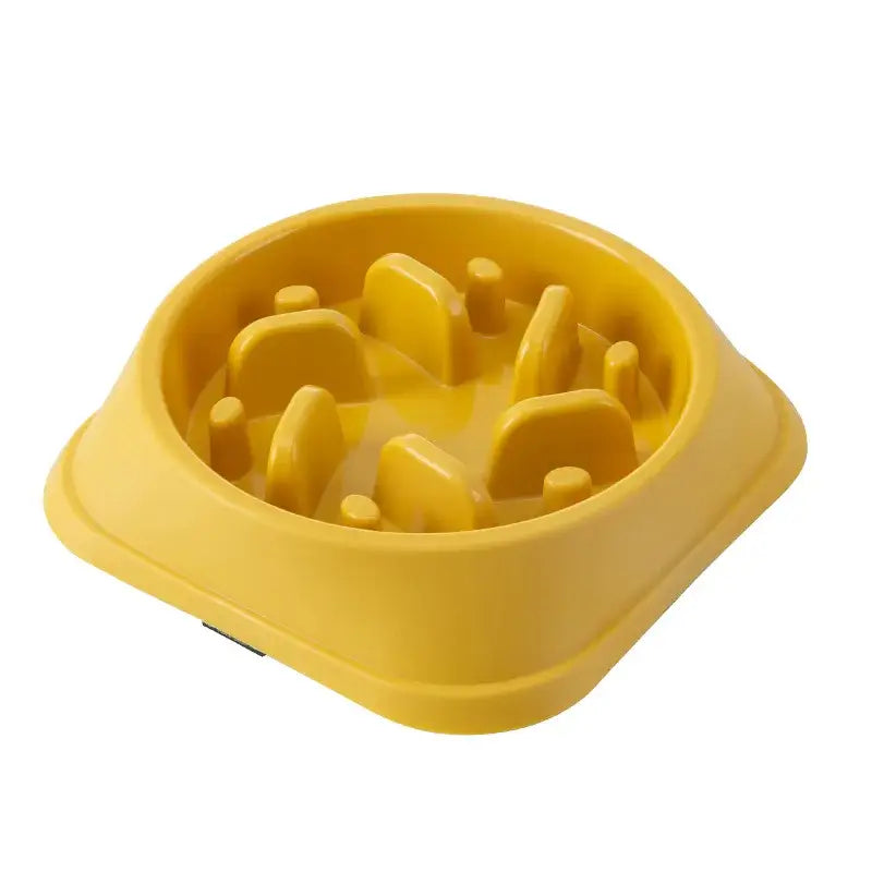 Yellow plastic pet food bowl with raised obstacles inside.