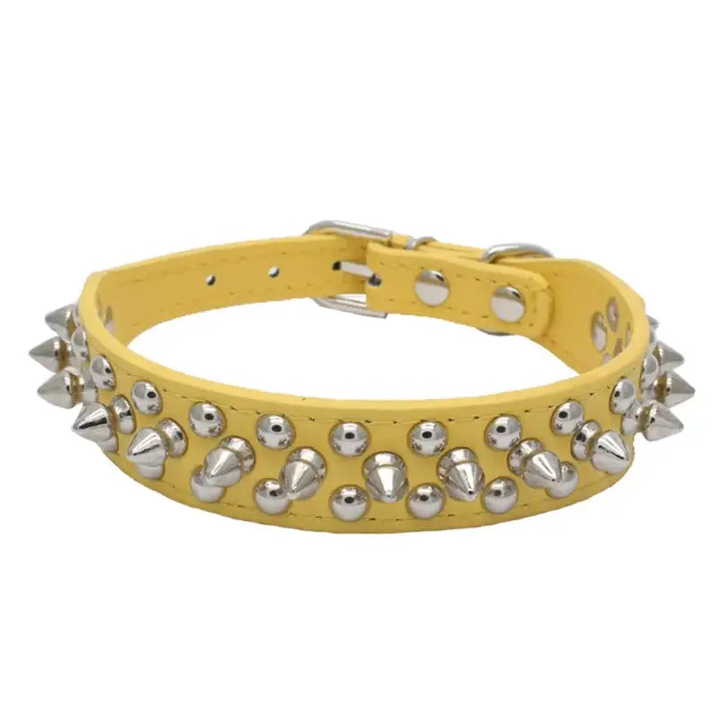 Yellow leather dog collar adorned with metal spikes and studs.