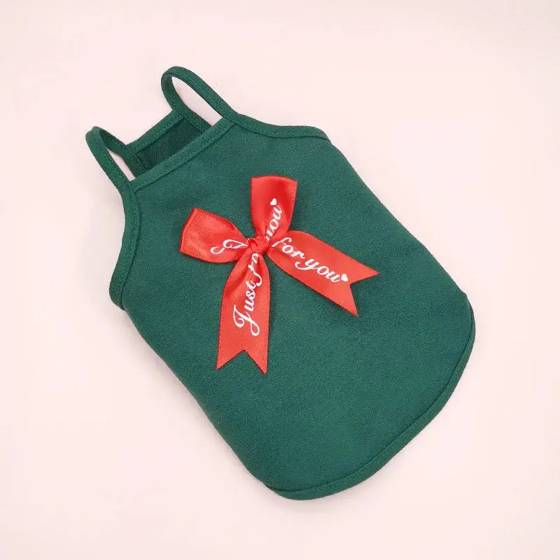 Green pet tank top with a red bow attached.