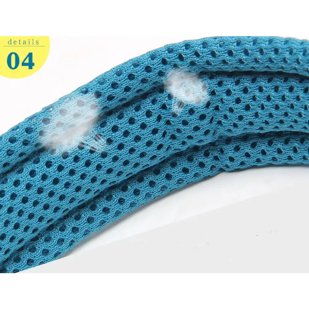 Teal mesh fabric with small holes and visible lint or debris on its surface.