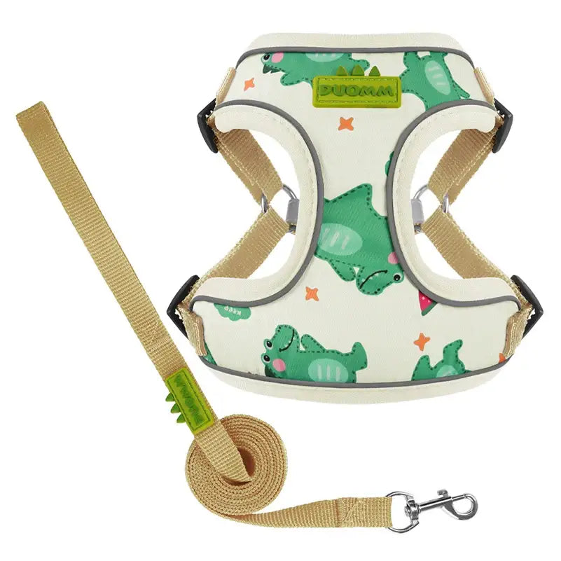 Dog harness with a green dinosaur pattern and matching leash.