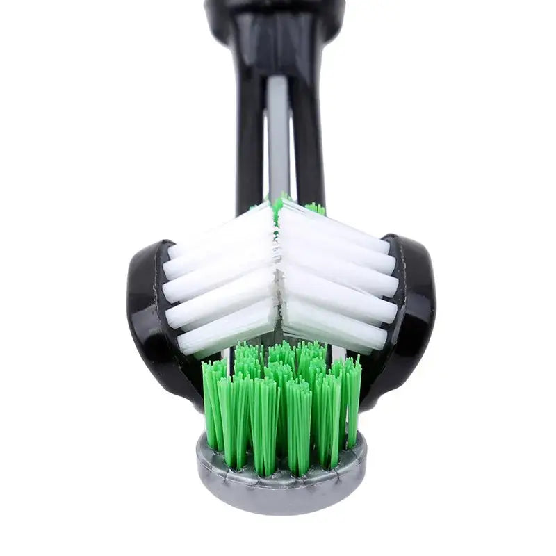 Dish scrubber brush with white and green bristles arranged in a circular pattern.