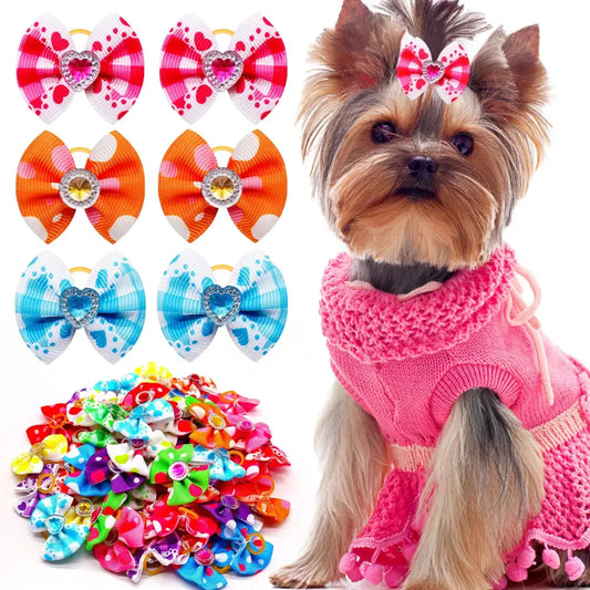 Yorkshire Terrier wearing a pink sweater and hair bow.