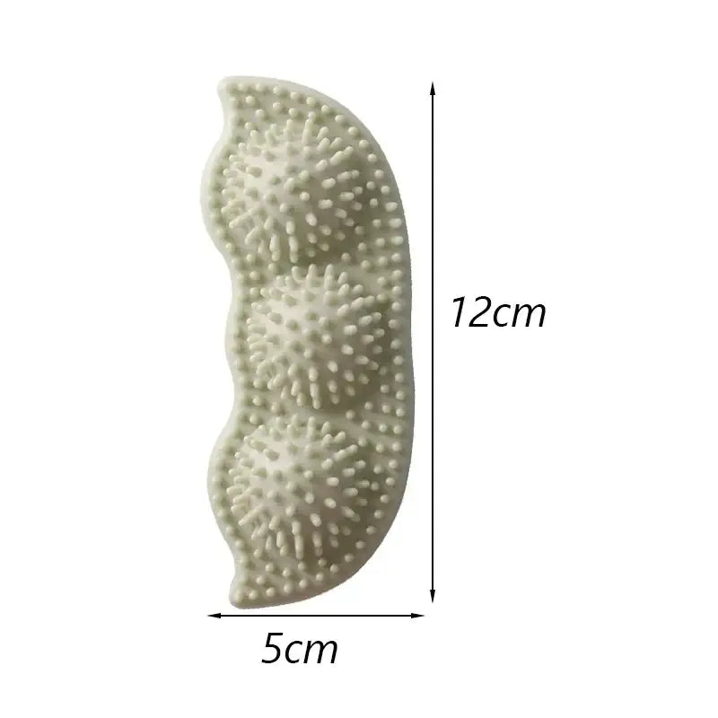 Curved, textured massage tool with spiky protrusions measuring 12cm by 5cm.