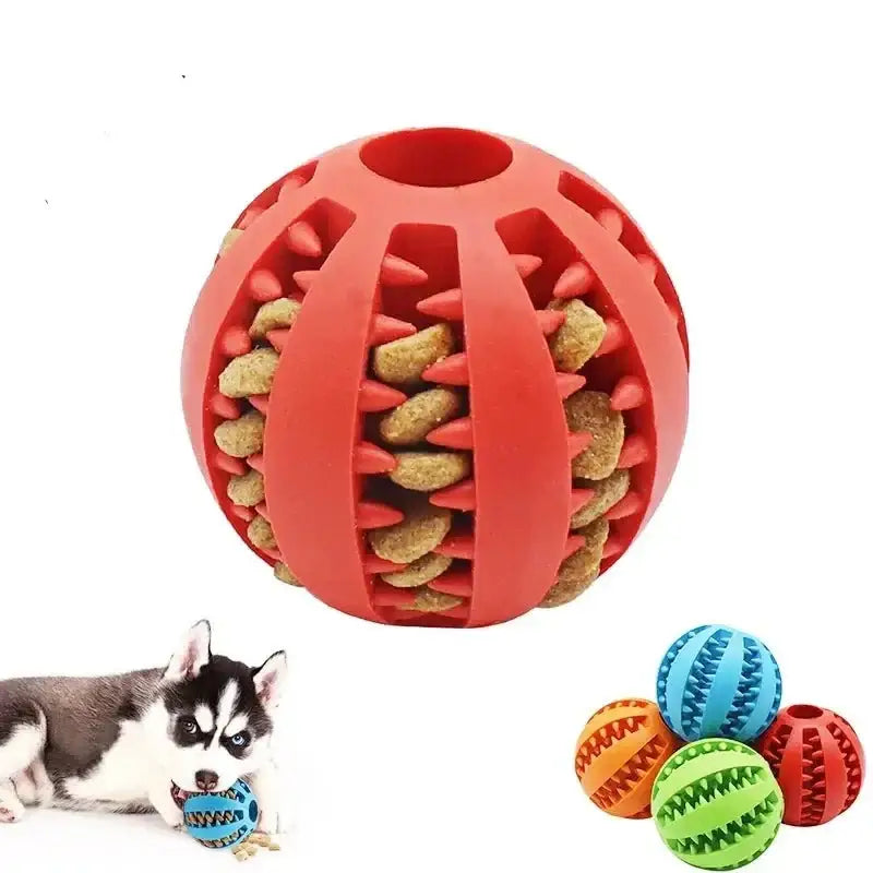 Red rubber ball with slits containing dog treats or kibble inside.