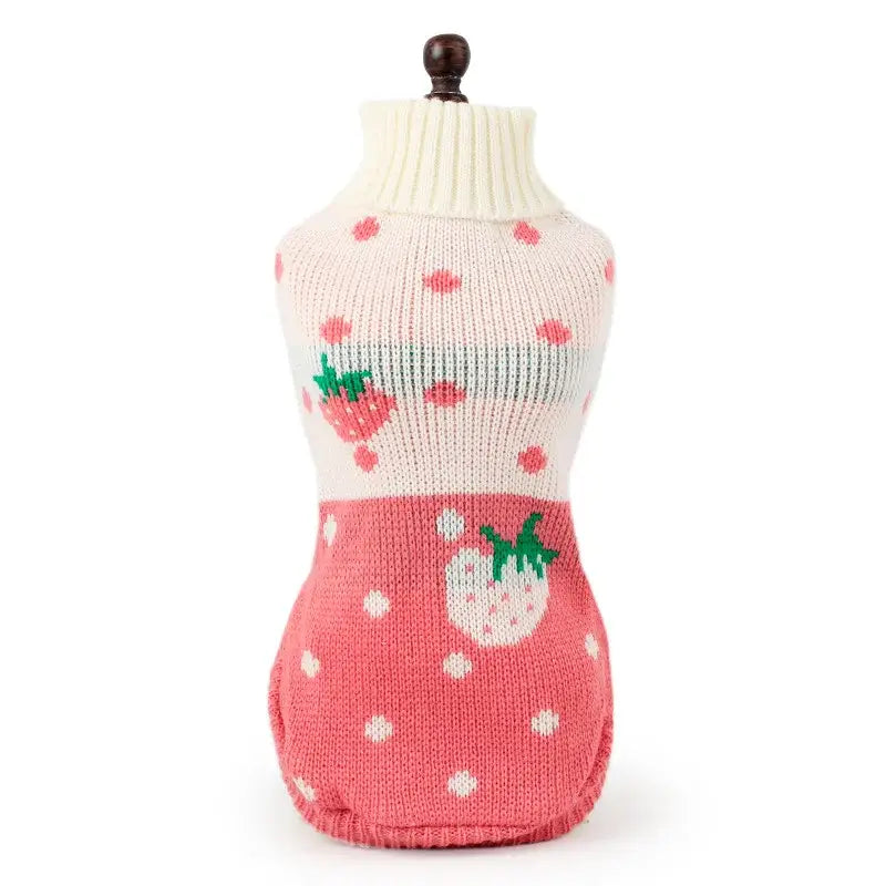 Knitted dog sweater with strawberry pattern and polka dots.