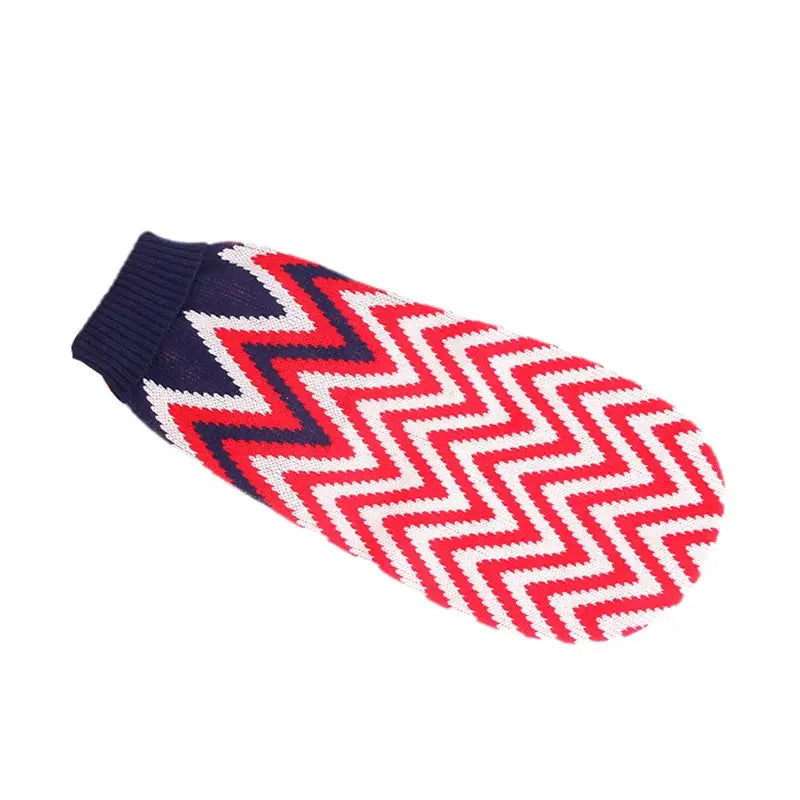 Knitted mitten with red, white, and navy blue zigzag pattern.