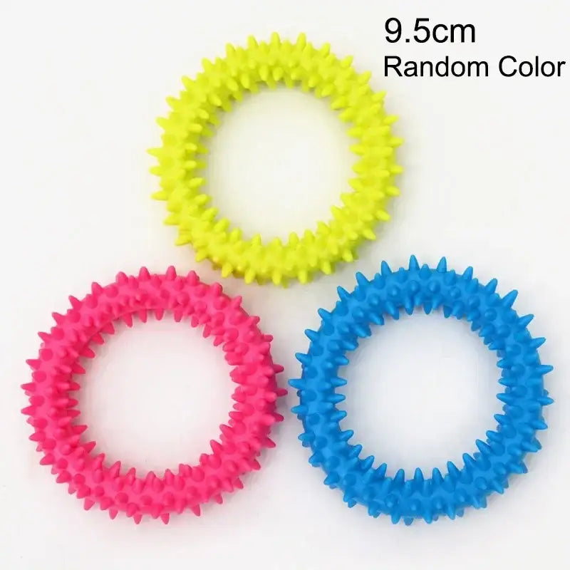 Colorful spiky rubber rings in yellow, pink, and blue.