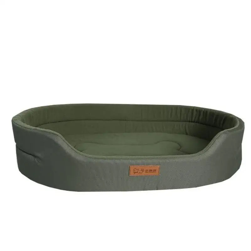 Oval-shaped dog bed with green cushioning and a gray outer shell.