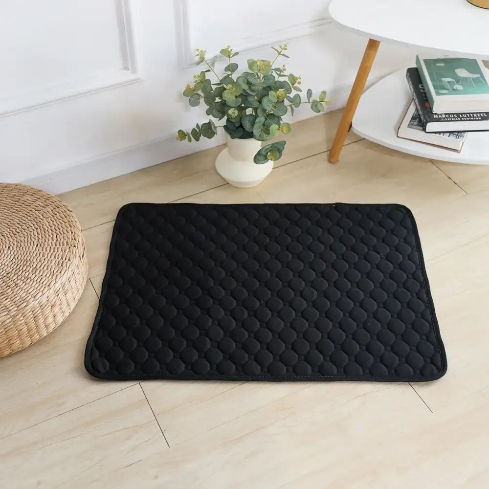 Black quilted rectangular floor mat.