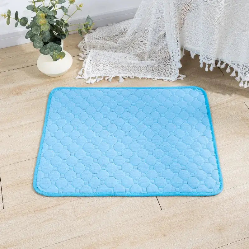 Light blue quilted cooling mat or pet pad.